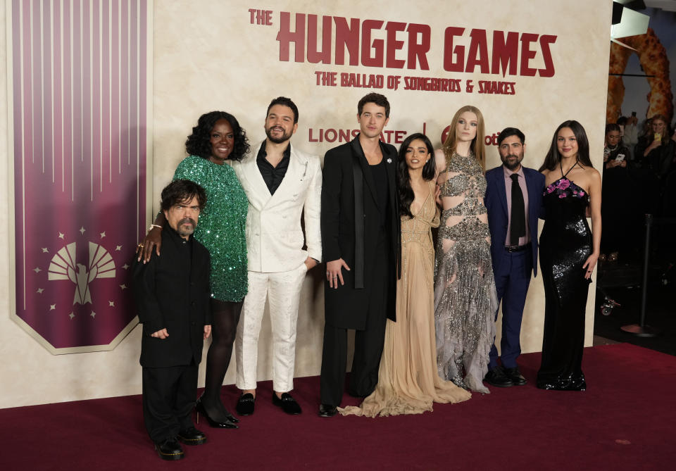 From left to right, "The Hunger Games: The Ballad of Songbirds & Snakes" cast members Peter Dinklage, Viola Davis, Josh Andres Rivera, Tom Blyth, Rachel Zegler, Hunter Schafer and Jason Schwartzman and singer Olivia Rodrigo pose together at the Los Angeles premiere of the film, Monday, Nov. 13, 2023, at the TCL Chinese Theatre. (AP Photo/Chris Pizzello)