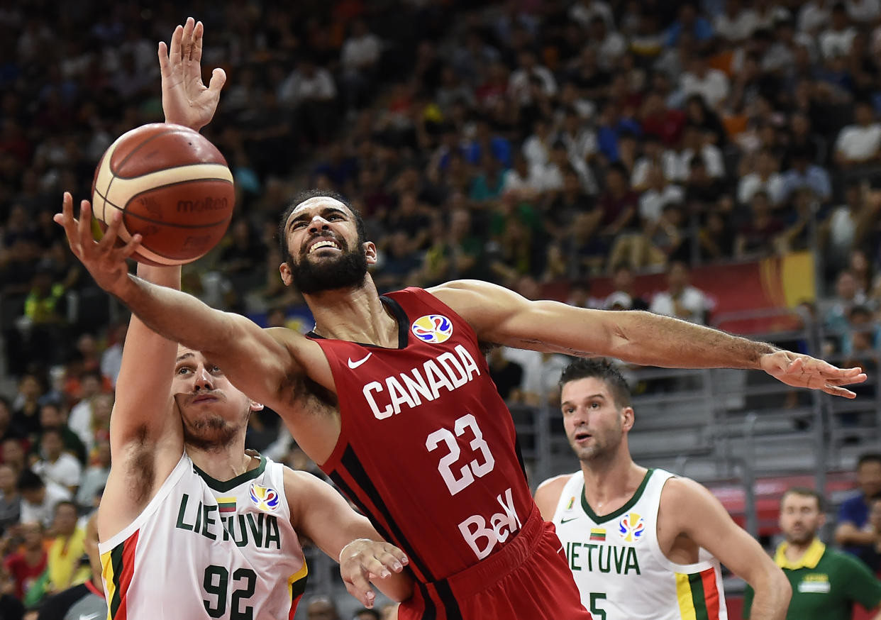 Canada's Phil Scrubb (C) fights for the ball with Lithuania's Edgaras Ulanovas (L) during the Basketball World Cup Group H game between Lithuania and Canada in Dongguan on September 3, 2019. (Photo by Ye Aung Thu / AFP)        (Photo credit should read YE AUNG THU/AFP/Getty Images)