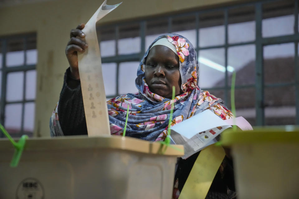 A woman casts her ballot at the Kibera primary school in Nairobi, Kenya, Tuesday Aug. 9, 2022. Kenyans are voting to choose between opposition leader Raila Odinga and Deputy President William Ruto to succeed President Uhuru Kenyatta after a decade in power. (AP Photo/Mosa'ab Elshamy)