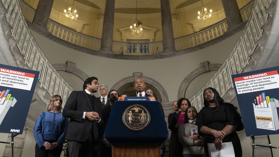 Mayor Eric Adams makes announcement on lawsuit against social media companies at City Hall in New York City. Norma Nazario, whose 15-year-old son Zackery died last year in a New York subway surfing accident after he found videos of the trend on social media, stands by his side, holding a picture of her son. - Lev Radin/Pacific Press/LightRocket/Getty Images