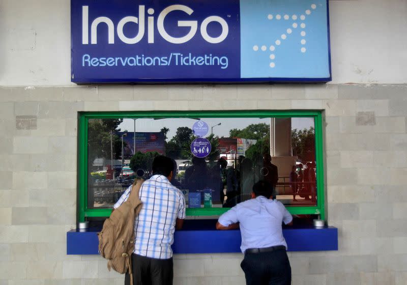 FILE PHOTO: Passengers stand at the ticket counter of Indigo Airlines at the airport on the outskirts of Agartala