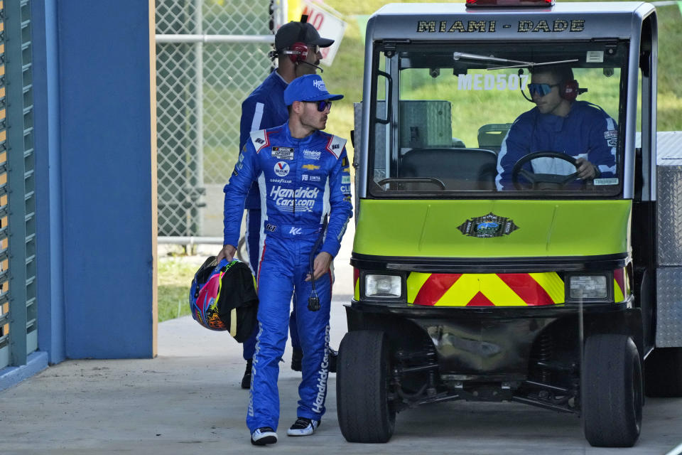 Kyle Larson, front left, heads to a medical checkup after an accident during a NASCAR Cup Series auto race at Homestead-Miami Speedway, Sunday, Oct. 22, 2023, in Homestead, Fla. (AP Photo/Wilfredo Lee)