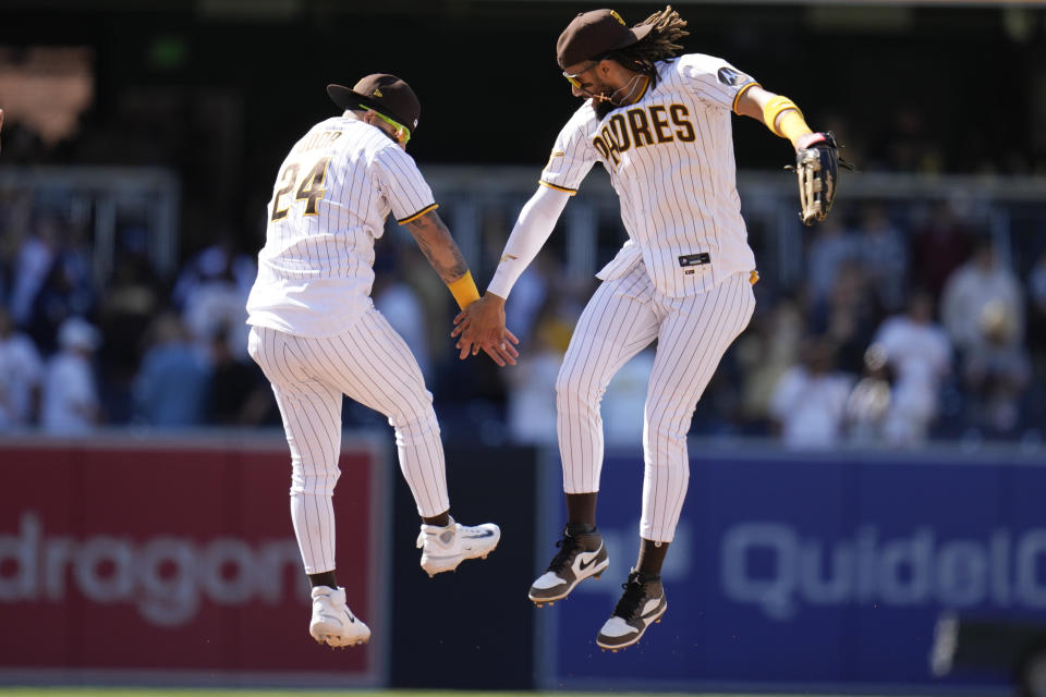 San Diego Padres right fielder Fernando Tatis Jr., right celebrates with teammate second baseman Rougned Odor after the Padres defeated the Cincinnati Reds 7-1 in a baseball game Wednesday, May 3, 2023, in San Diego. (AP Photo/Gregory Bull)