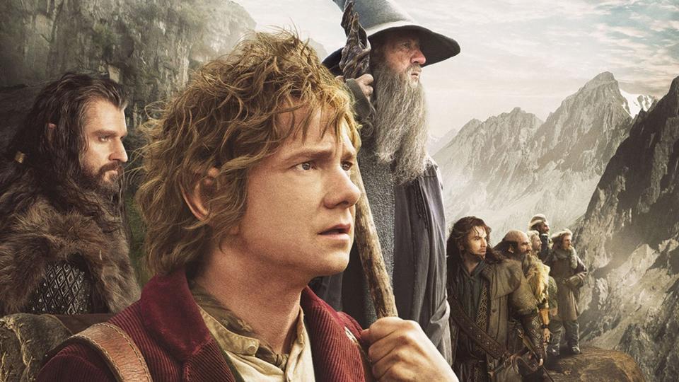 A still from the movie The Hobbit, showing the main cast of characters looking off into the distance