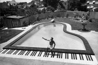 <p>Liberace enjoys the piano-shaped pool at his home in 1954.</p>