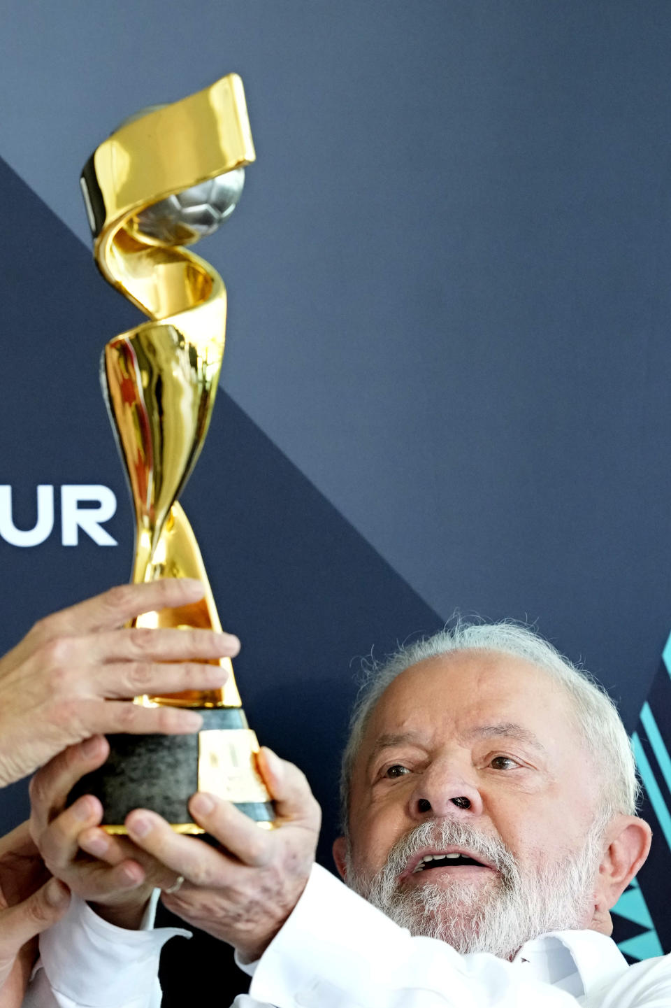 Brazil's President Luiz Inacio Lula da Silva holds the FIFA Women's World Cup trophy during the trophy's tour ahead of the Australia - New Zealand 2023 World Cup soccer tournament at Planalto palace in Brasilia, Brazil, Thursday, March 30, 2023. (AP Photo/Eraldo Peres)