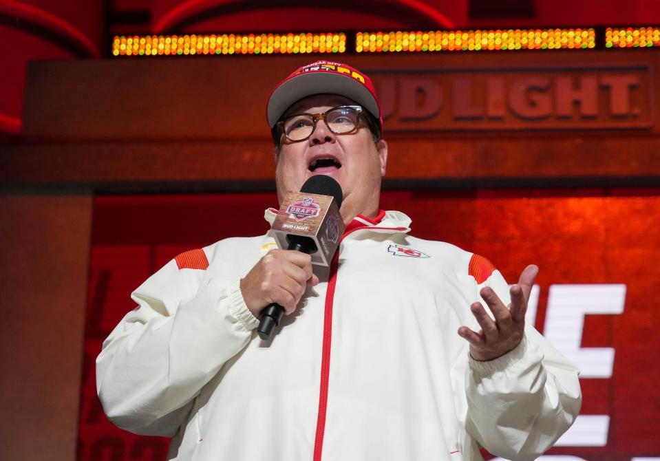 Actor Eric Stonestreet dons Kansas City Chiefs gear while on stage during the first round of the 2023 NFL Draft.
