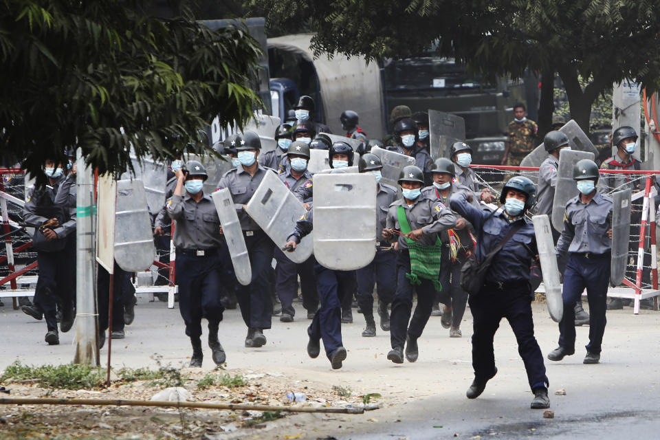 Police charge forward to disperse protesters in Mandalay, Myanmar on Saturday, Feb. 20, 2021. Security forces in Myanmar ratcheted up their pressure against anti-coup protesters Saturday, using water cannons, tear gas, slingshots and rubber bullets against demonstrators and striking dock workers in Mandalay, the nation's second-largest city. (AP Photos)