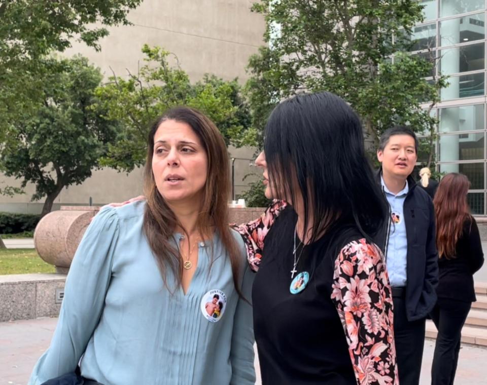 Nancy Iskander, mother of two boys struck and killed in September 2020, is comforted by friends outside a Van Nuys courthouse in June.