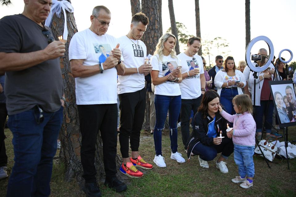 At an April vigil for Jared Bridegan, daughter Bexley wipes tears from her mother Kirsten Bridegan's eyes as other family members paid their respects. Bridegan was shot and killed on Feb. 16 in Jacksonville Beach in front of his toddler.