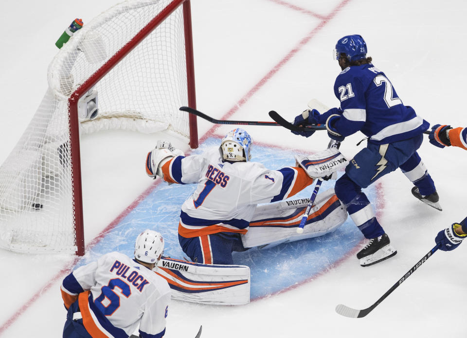 Tampa Bay Lightning's Brayden Point (21) scores on New York Islanders goalie Thomas Greiss (1) during the first period of an NHL Eastern Conference final playoff game, Monday, Sept. 7, 2020, in Edmonton, Alberta. (Jason Franson/The Canadian Press via AP)