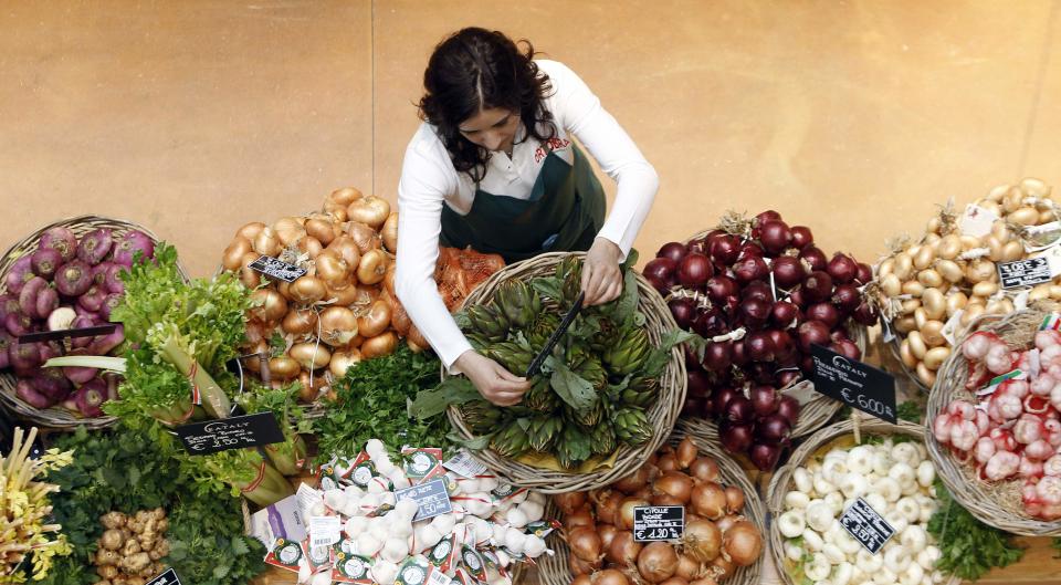 An employee arranges pricetags at a vegetables work bench during the opening day of upmarket Italian food hall chain Eataly's flagship store in downtown Milan, March 18, 2014. Eataly, which began with the idea that there should be a place to buy, eat and study high-quality Italian food and wine, has 25 food emporiums in the United States, Turkey, Japan and Dubai. REUTERS/Alessandro Garofalo (ITALY - Tags: SOCIETY FOOD BUSINESS)