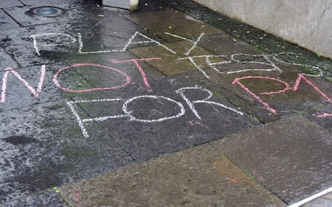 A chalk slogan on the pavement outside the Scottish Parliament opposing the testing of Primary One pupils - Credit: Corbis News