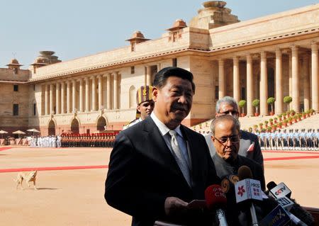China's President Xi Jinping speaks with the media next to his Indian counterpart Pranab Mukherjee after inspecting the guard of honour during his ceremonial reception at the forecourt of India's Rashtrapati Bhavan presidential palace in New Delhi September 18, 2014. REUTERS/Stringer