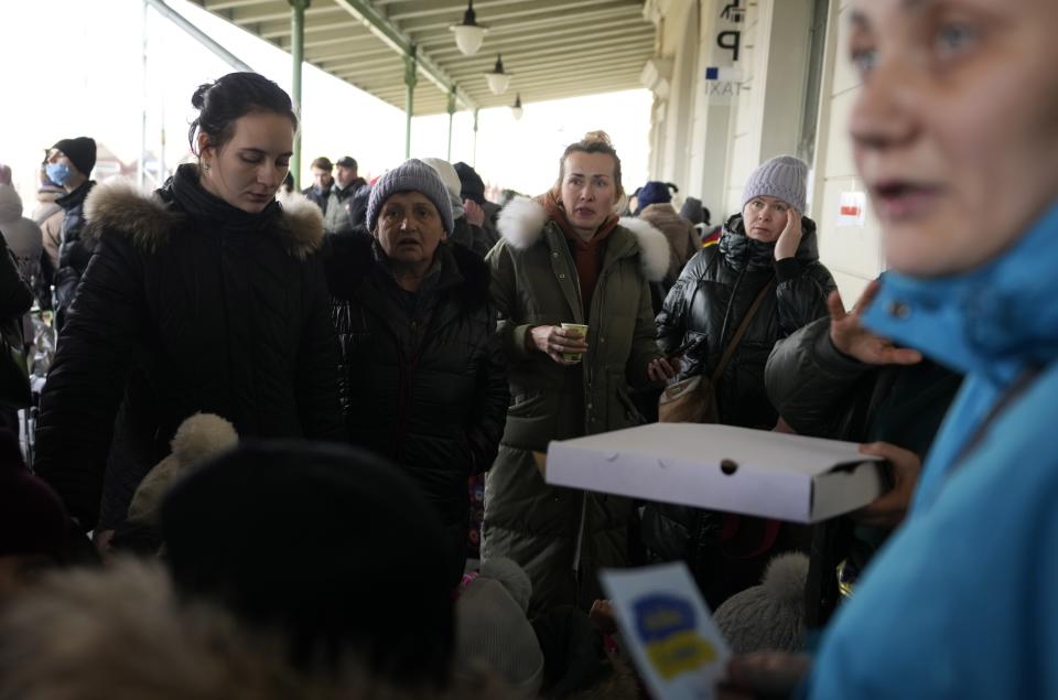 People from Ukraine wait at a train station in Przemysl, southeastern Poland, Wednesday, March 2, 2022. Seven days into the war, roughly 874,000 people have fled Ukraine and the U.N. refugee agency warned the number could cross the 1 million mark soon. (AP Photo/Markus Schreiber)
