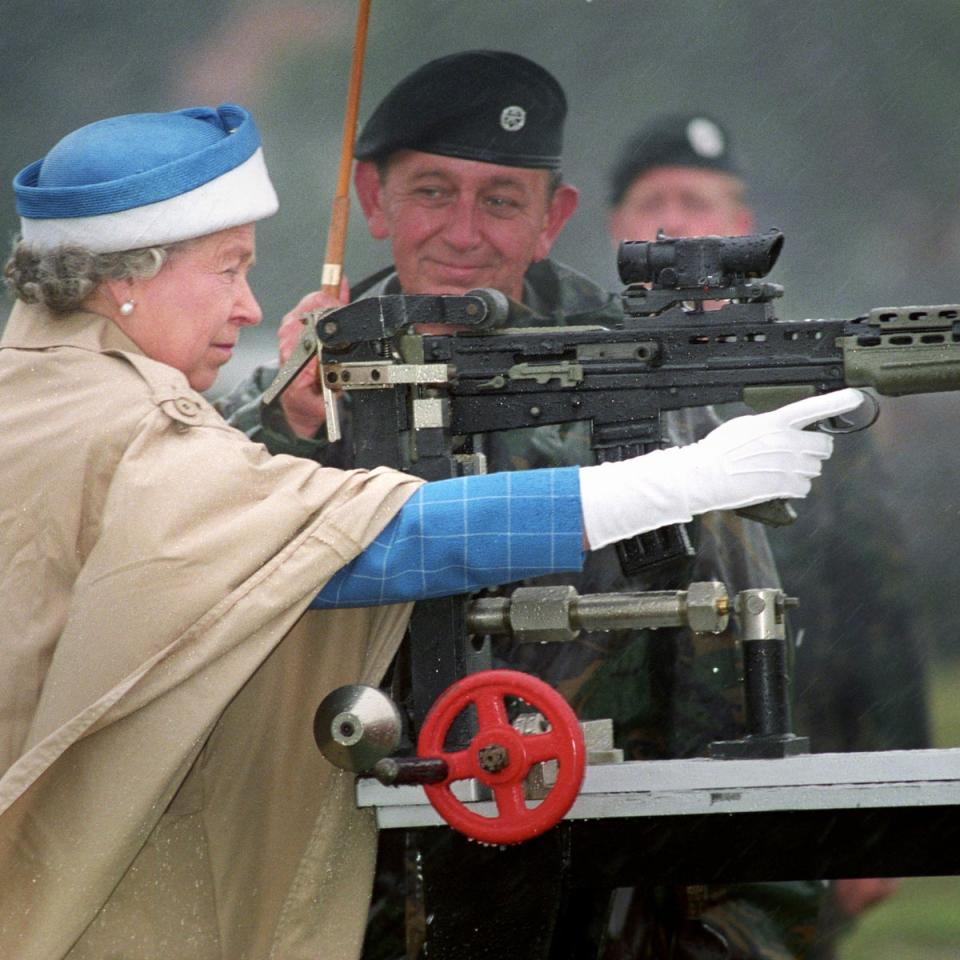 Queen Elizabeth II, with Chief Instructor, Small Arms Corp LT Col George Harvey, firing the last shot on a standard SA 80 rifle when she attended the centenary of the Army Rifle Association at Bisley, 1993 (PA)