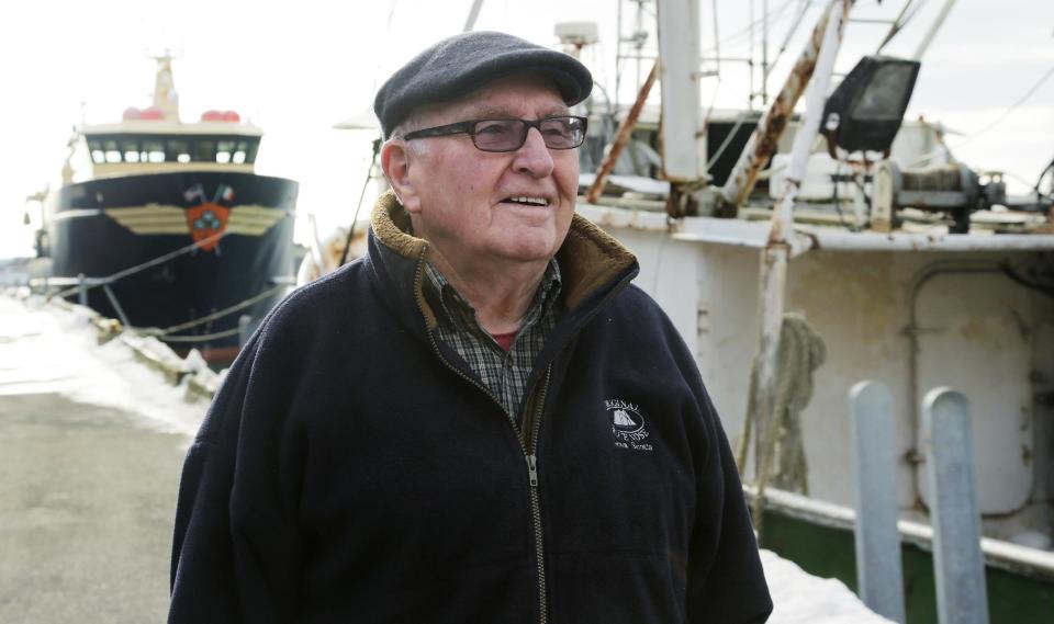 In this photo taken Wednesday, Feb. 13, 2013, Ron Gilson, a 79-year-old life Gloucester native, walks along the fish pier in Gloucester, Mass. In Gilson's life he's worked throughout the fishing industry from working on the wharf in his youth to a historian on Gloucester in his later life. In May, a massive reduction is coming to the catch limit for cod caught in the Gulf of Maine, just outside Gloucester Harbor, and the cuts are acknowledged by fishermen, regulators and environmentalists to be devastating, and perhaps fatal, for the historic industry. (AP Photo/Charles Krupa)