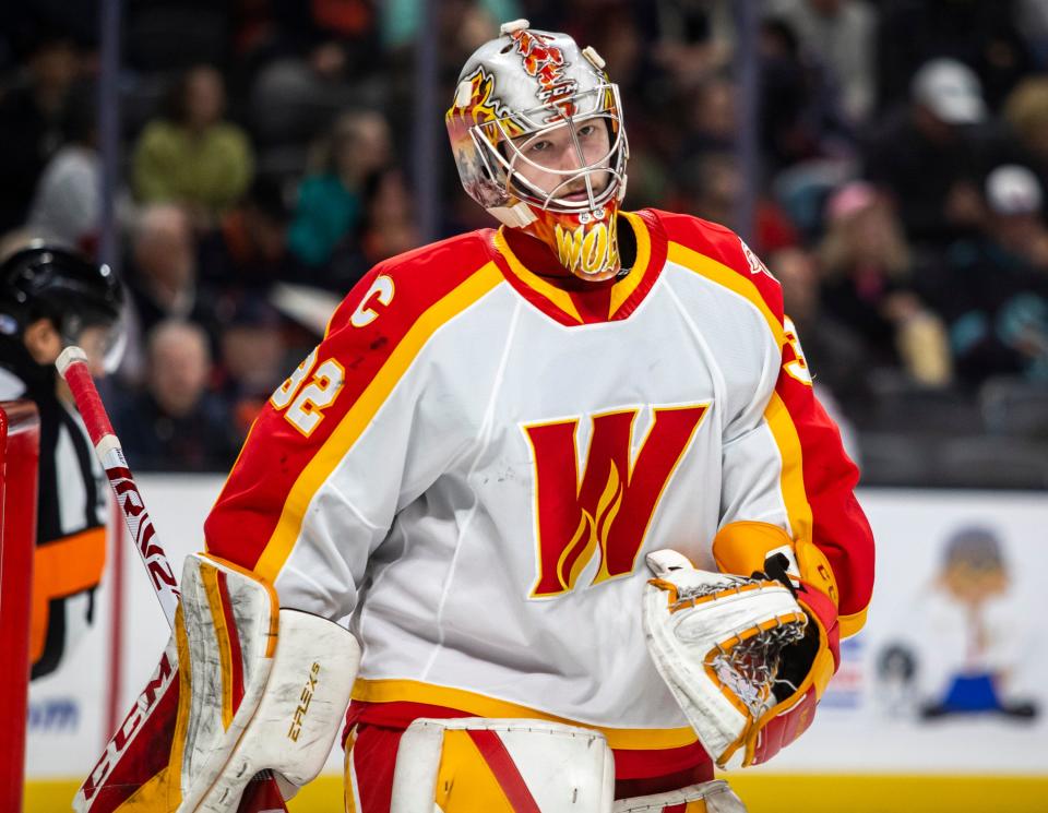 Calgary goaltender Dustin Wolf (32) skates away from the goal during a break in play during the first period of their game at Acrisure Arena in Palm Desert, Calif., Wednesday, April 5, 2023. 