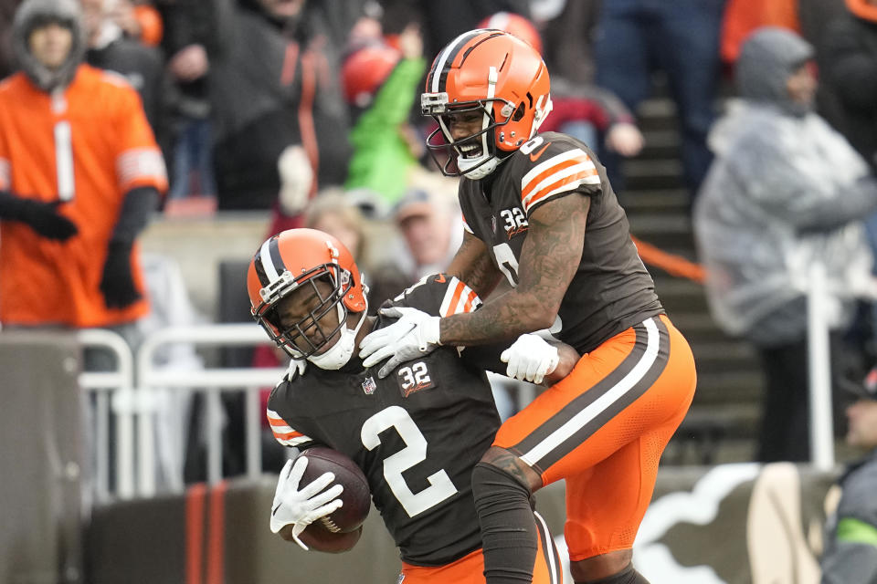 Cleveland Browns wide receiver Elijah Moore (8) celebrates with wide receiver Amari Cooper (2) after Cooper scores a touchdown in the second half of an NFL football game against the Chicago Bears in Cleveland, Sunday, Dec. 17, 2023. (AP Photo/Sue Ogrocki)