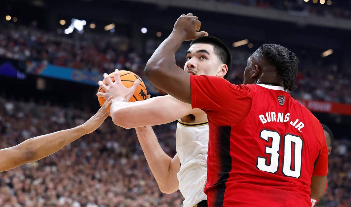 N.C. State’s DJ Burns Jr. (30) and Casey Morsell (14), left, defend Purdue’s Zach Edey (15) during the first half of N.C. State’s game against Purdue in the NCAA Tournament national semfinals at State Farm Stadium in Glendale, Ariz., Saturday, April 6, 2024. Ethan Hyman/ehyman@newsobserver.com