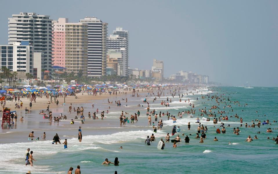 Beachgoers pack the sands of Daytona Beach on Saturday.