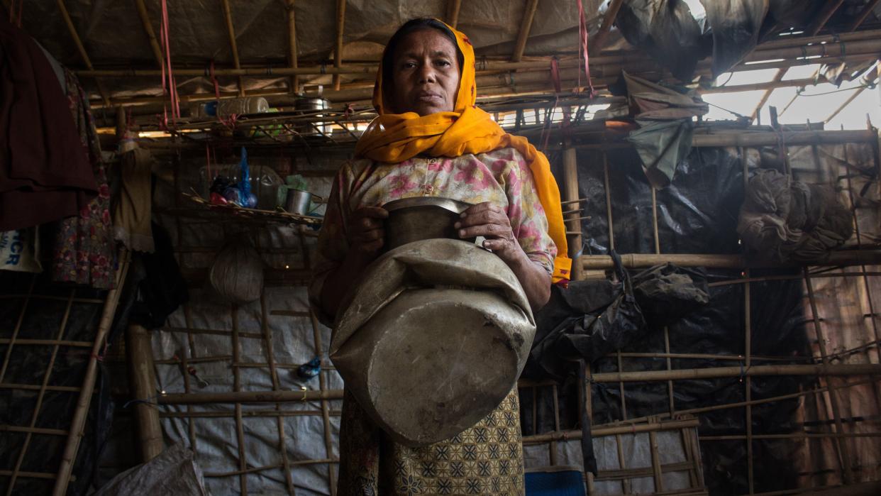 Anwar Beguma shows a water pot smashed by an elephant that trampled her family's house in Kutupalong refugee camp in Bangladesh. Her husband, Yakub Ali, died in the incident. (Photo: Kazi Riasat Alve for HuffPost)