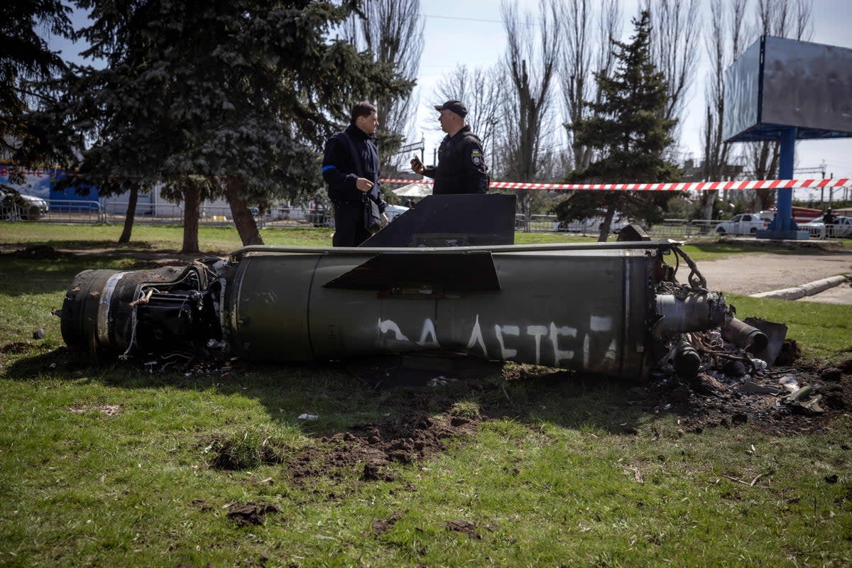 Ukrainian police inspect the remains of a large rocket with the words ‘for [the] children’ in Russian next to the main building of a train station in Kramatorsk, eastern Ukraine (AFP/Getty)