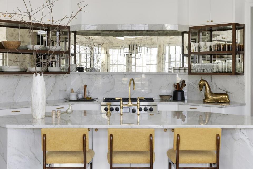 To reflect natural light from perimeter windows, Fontana used her versatile, 8-by-20-inch mirrored Patina tiles in the silvery Siren colorway as an accent along the back wall of her kitchen