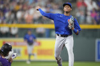 Chicago Cubs shortstop Sergio Alcantara, right, throws to first base after forcing out Colorado Rockies' Brendan Rodgers at second base on the front end of a double play hit into by Charlie Blackmon to end the fifth inning of a baseball game Wednesday, Aug. 4, 2021, in Denver. (AP Photo/David Zalubowski)