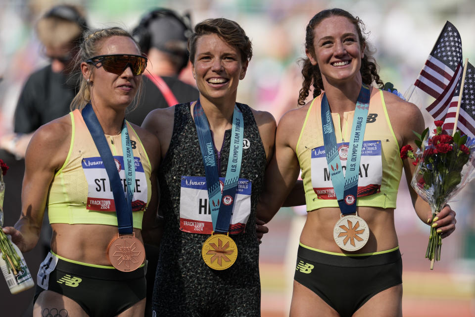First place winner Nikki Hiltz, center, Second place winner Emily Mackay, right and Elle St. Pierre pose for a photo after they ran the women's 1500-meter final during the U.S. Track and Field Olympic Team Trials, Sunday, June 30, 2024, in Eugene, Ore. (AP Photo/George Walker IV)