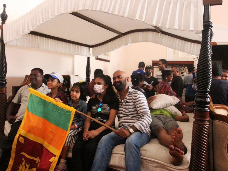 People lie on bed in Sri Lanka President's official residence