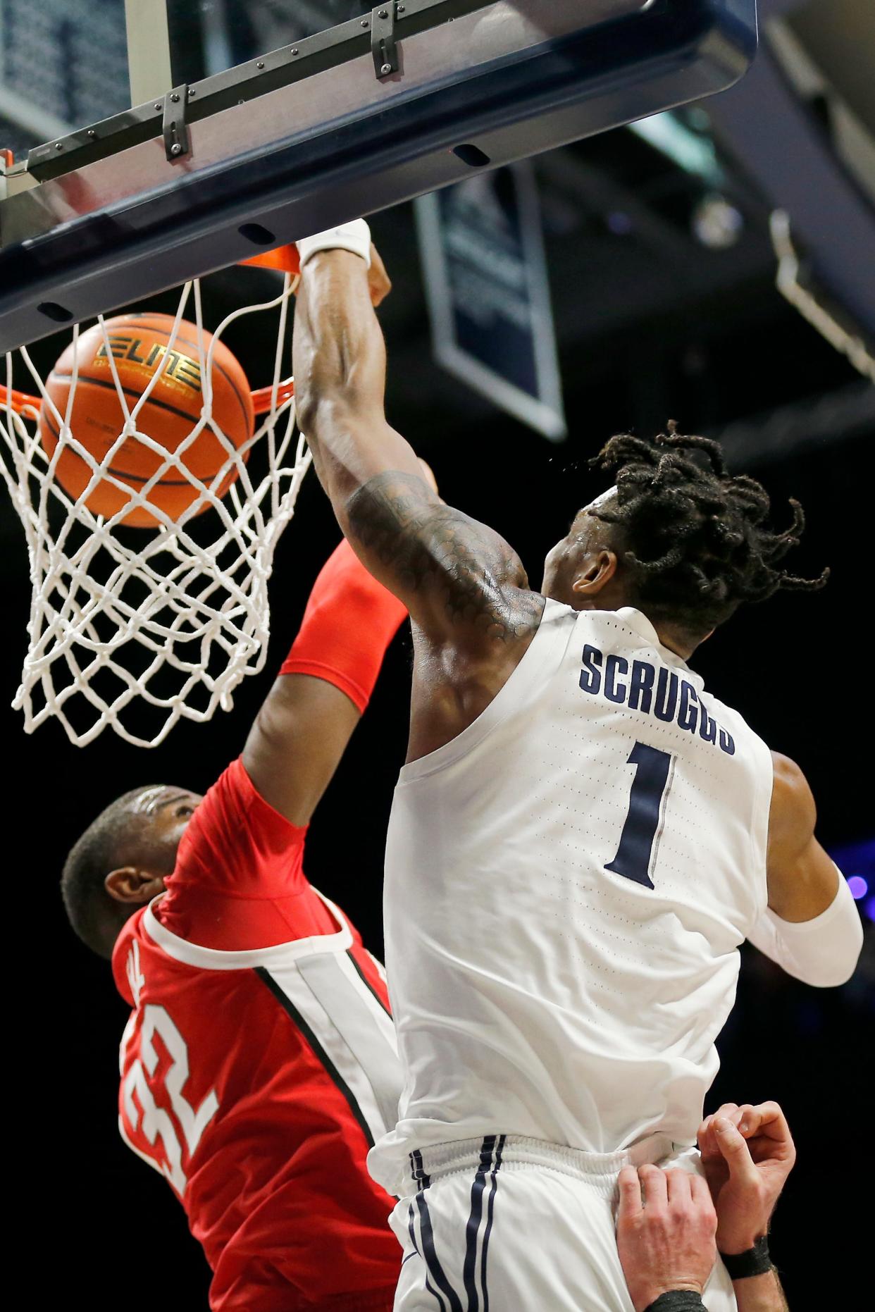 Xavier Musketeers guard Paul Scruggs (1) drives and dunks over Ohio State Buckeyes forward E.J. Liddell (32) in the second half of the NCAA basketball game between the Xavier Musketeers and the Ohio State Buckeyes at the Cintas Center in Cincinnati on Thursday, Nov. 18, 2021. Xavier defeated the 19-ranked Buckeyes, 71-65.