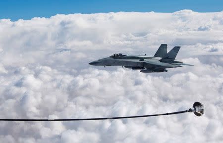 A supplied image of a Royal Australian Air Force F/A-18A Hornet refuelling from a KC-30A Multi Role Tanker Transport in the skies over the Middle East region April 22, 2016. Australian Defence Force/Handout via REUTERS