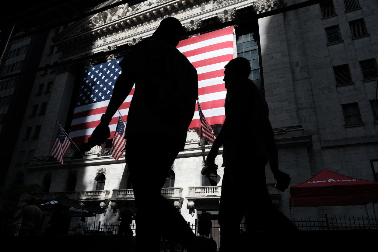 NEW YORK, NEW YORK - MAY 23: People walk by the New York Stock Exchange (NYSE) on May 23, 2022 in New York City. After a week of steep losses, markets were up in Monday morning trading.  (Photo by Spencer Platt/Getty Images)