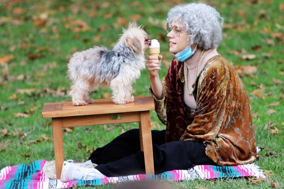 <p>Kate McKinnon wears a grey wig and feeds ice cream to a furry friend while filming a skit for<i> Saturday Night Live</i> on Tuesday in N.Y.C. </p>