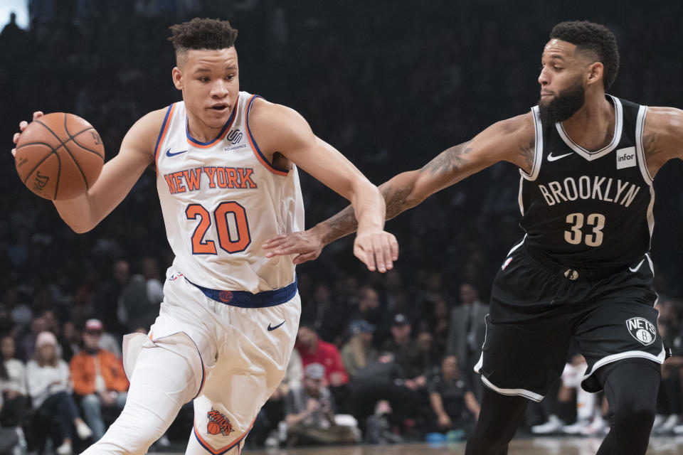 New York Knicks forward Kevin Knox (20) drives to the basket against Brooklyn Nets guard Allen Crabbe (33) during the first half of an NBA basketball game, Friday, Oct. 19, 2018, in New York. (AP Photo/Mary Altaffer)