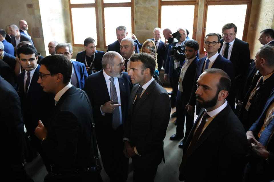 France's President Emmanuel Macron, center right, speaks with Armenia's Prime Minister Nikol Pasjinian after a group photo during a meeting of the European Political Community at Prague Castle in Prague, Czech Republic, Thursday, Oct 6, 2022. Leaders from around 44 countries are gathering Thursday to launch a "European Political Community" aimed at boosting security and economic prosperity across the continent, with Russia the one major European power not invited. (AP Photo/Petr David Josek)