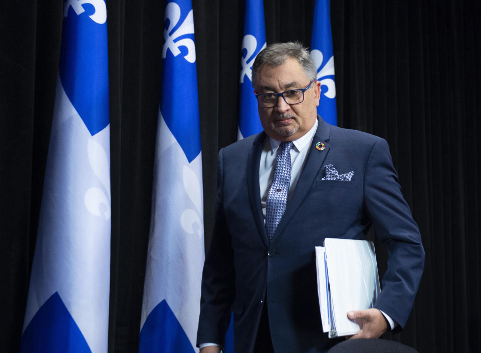 In this Tuesday, April 7, 2020, photo, Horacio Arruda, Quebec director of National Public Health, walks in a news conference on the COVID-19 pandemic, at the legislature in Quebec City. (Jacques Boissinot/The Canadian Press via AP)