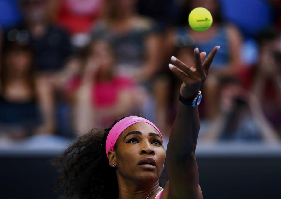 Serena Williams of the U.S. serves to Alison Van Uytvanck of Belgium during their women's singles first round match at the Australian Open 2015 tennis tournament in Melbourne January 20, 2015. REUTERS/Issei Kato (AUSTRALIA - Tags: SPORT TENNIS)