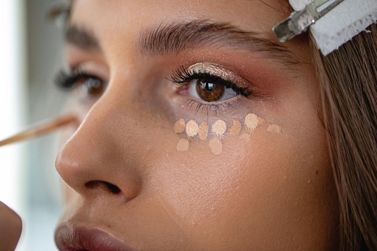 Professional model in a beauty salon enjoying getting makeup on