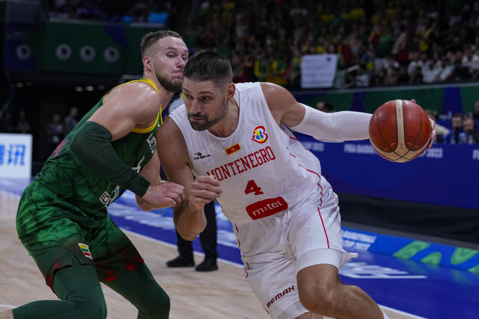 Montenegro center Nikola Vucevic (4) drives on Lithuania forward Tadas Sedekerskis (8) during the second half of a Basketball World Cup group D match in Manila, Philippines Tuesday, Aug. 29, 2023. Lithuania defeated Montenegro 91-71. (AP Photo/Michael Conroy)