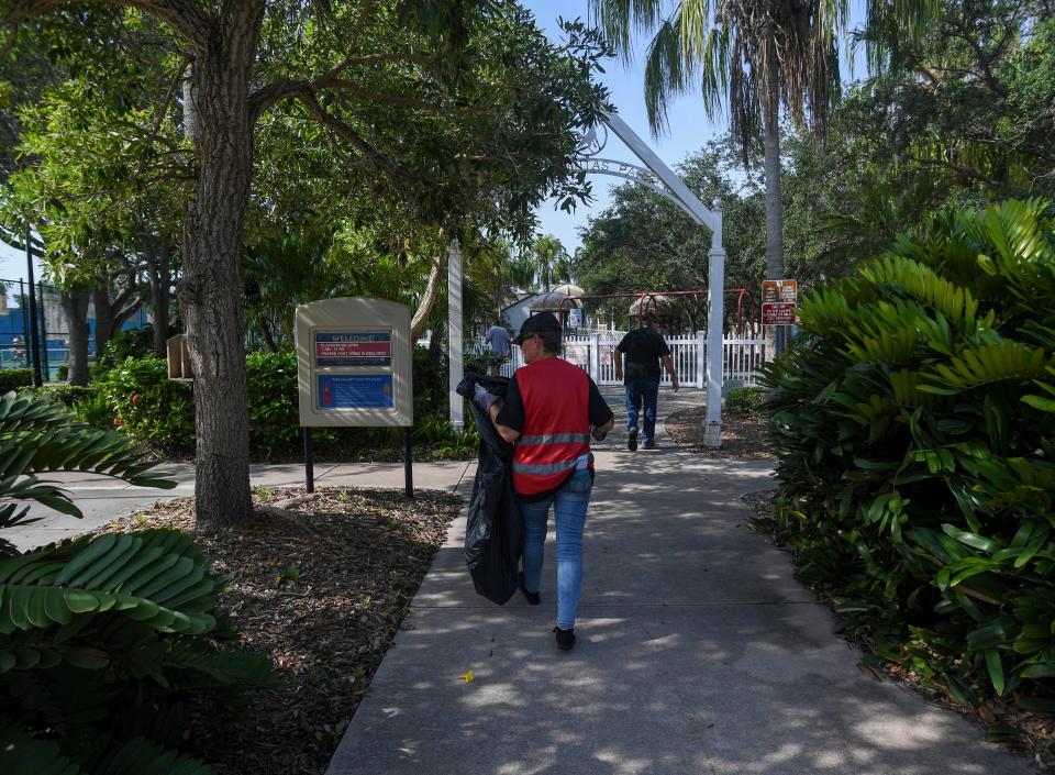 Employees of a community works program at The Source, a local homeless resource center, work together to help pick up garbage and pressure wash sidewalks around properties downtown in Vero Beach. The program is designed to give Source members an opportunity to earn their way out of homelessness. 
