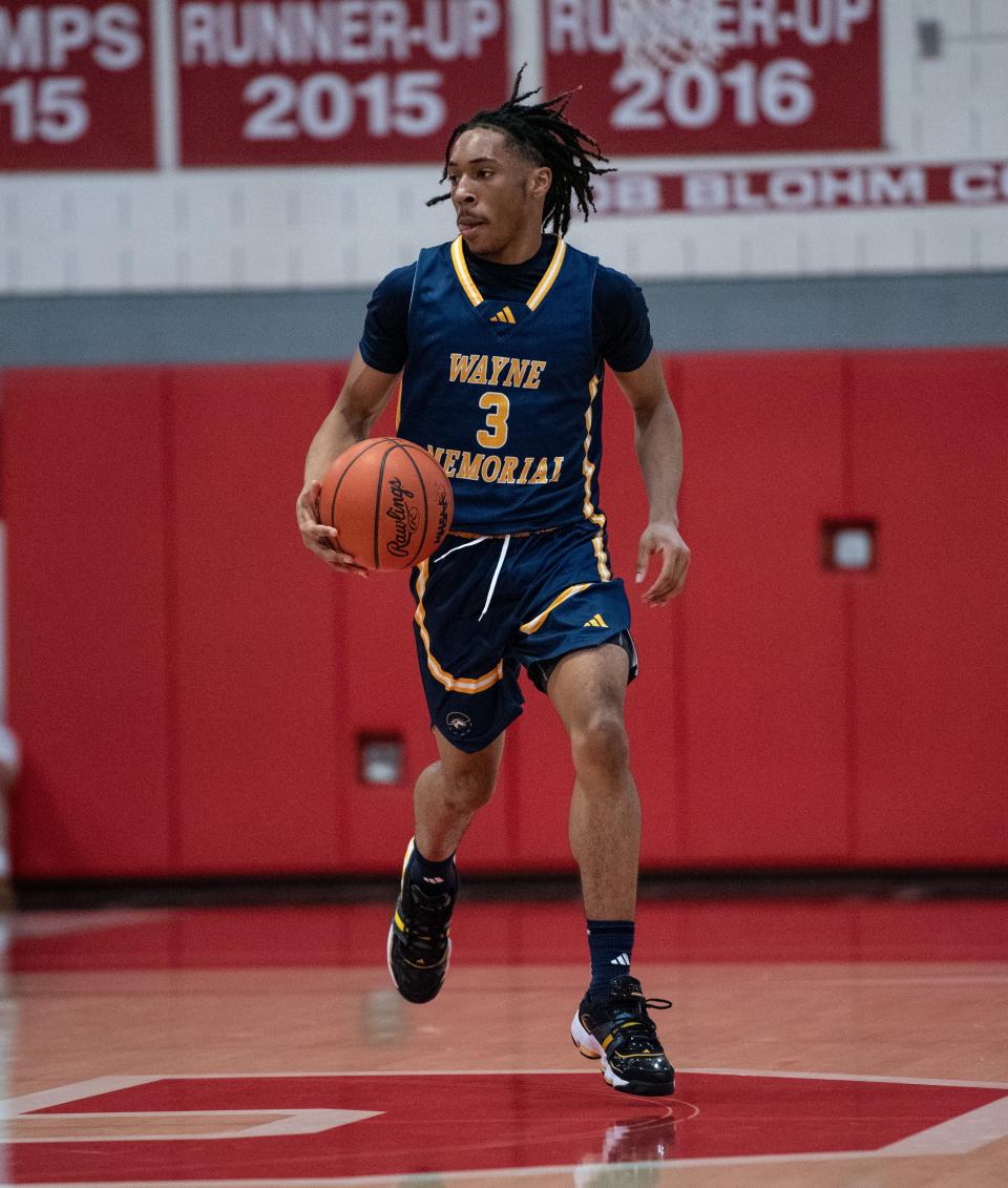 Wayne Memorial's Carlos Medlock dribbles up the floor during a Division 1 boys basketball district championship on Friday, March 1, 2024.