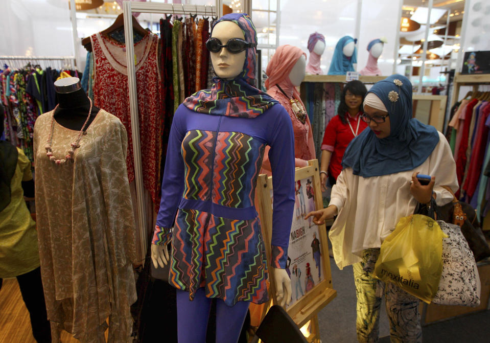 In this Thursday, May 30, 2013 photo, a women's Islamic swim suit is displayed at an exhibitor's booth during Islamic Fashion Fair in Jakarta, Indonesia. Indonesia is the world's most populous Muslim country, but most people follow a moderate form of the religion. Many women wear bright and creative headscarves along with brand-name jeans and long-sleeved fitted shirts. (AP Photo/Dita Alangkara)