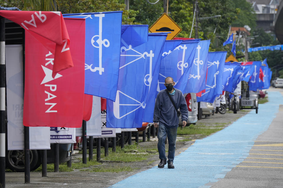 Flags of Malaysia's ruling National Front coalition, or Barisan Nasional (blue) and Pakatan Harapan (Alliance of Hope) coalition (red) are displayed in Kuala Lumpur, Malaysia, Thursday, Nov. 17, 2022. Malaysia's general elections will take place Saturday, over a month after Prime Minister Ismail Sabri Yaakob dissolved Parliament and announced snap elections. The country's longest-serving coalition is seeking to regain its dominance after a shocking loss in 2018, but political reformers are aiming for a second surprise win. (AP Photo/Vincent Thian)