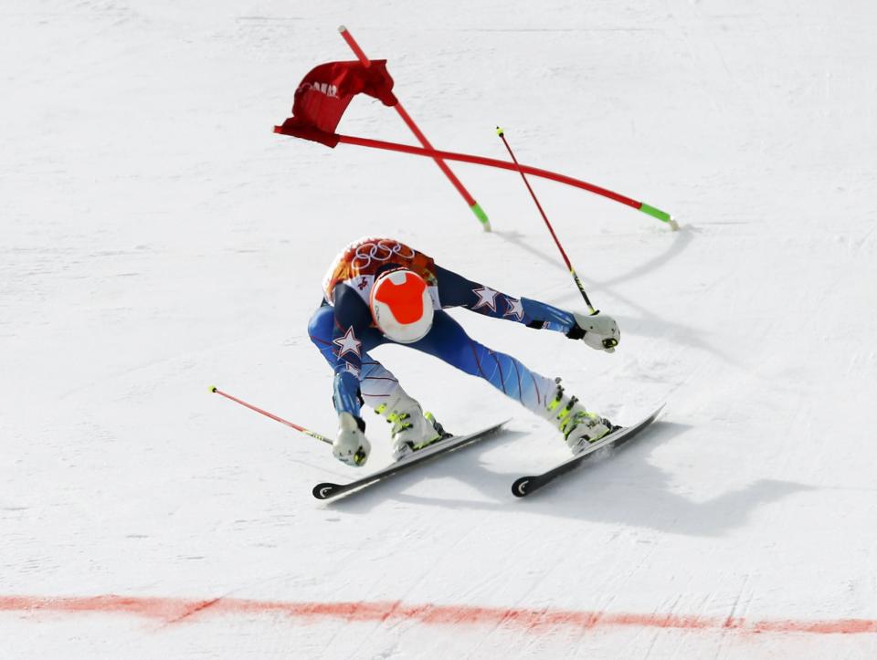 Bode Miller of the U.S. lunges towards the finish line during the first run of the men's alpine skiing giant slalom event in the Sochi 2014 Winter Olympics at the Rosa Khutor Alpine Center February 19, 2014. REUTERS/Mike Segar (RUSSIA - Tags: OLYMPICS SPORT SKIING TPX IMAGES OF THE DAY)