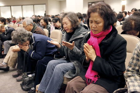 Participants pray for Canadian pastor Hyeon Soo Lim who is being held in North Korea during a joint multi-cultural prayer meeting at Light Korean Presbyterian Church in Toronto, December 20, 2015. REUTERS/Hyungwon Kang