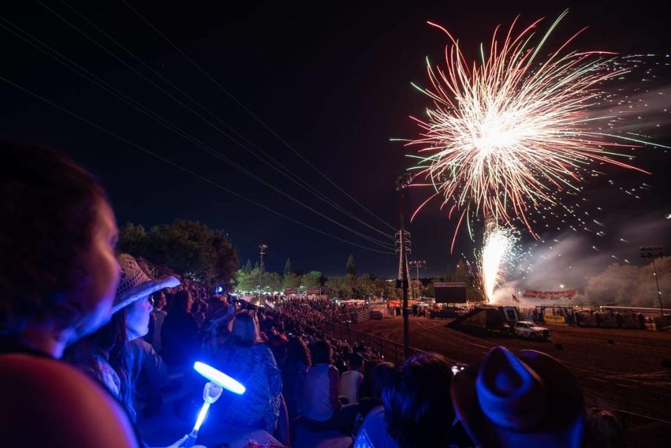 Arianna Sorensen spins a toy light as she watches the fireworks display at the 61st Folsom Pro Rodeo on Friday, July 1, 2022, at Dan Russell Rodeo Arena.