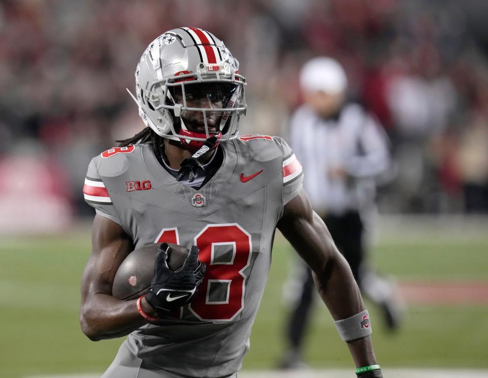 Nov. 11, 2023; Columbus, Oh., USA; 
Ohio State Buckeyes wide receiver Marvin Harrison Jr. (18) scores the first touchdown of the game during the first half of Saturday's NCAA Division I football game against the Michigan State Spartans.