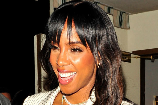 Kelly Rowland in a white tee, leather leggings, a statement